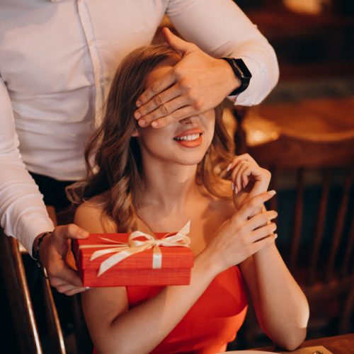 man-giving-gift-box-valentines-day-restaurant