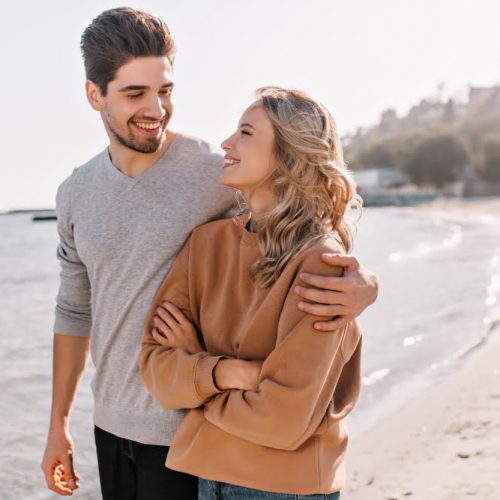 pleasant-young-man-embracing-girlfriend-nature-outdoor-portrait-pleased-blonde-girl-posing-sea-with-husband