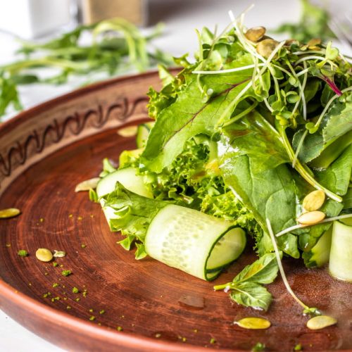 vegetarian-useful-green-salad-with-avocado-cucumber-arugula-micro-green-seasoned-with-olive-oil